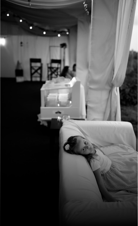 young child relaxes at a wedding